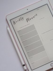 Close-up of a digital weekly planner displayed on a tablet with stylus.