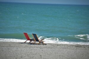 red and brown chair on beach during daytime