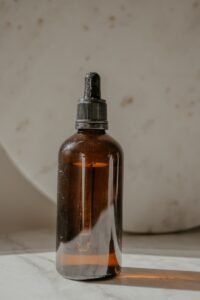 brown glass bottle on white table